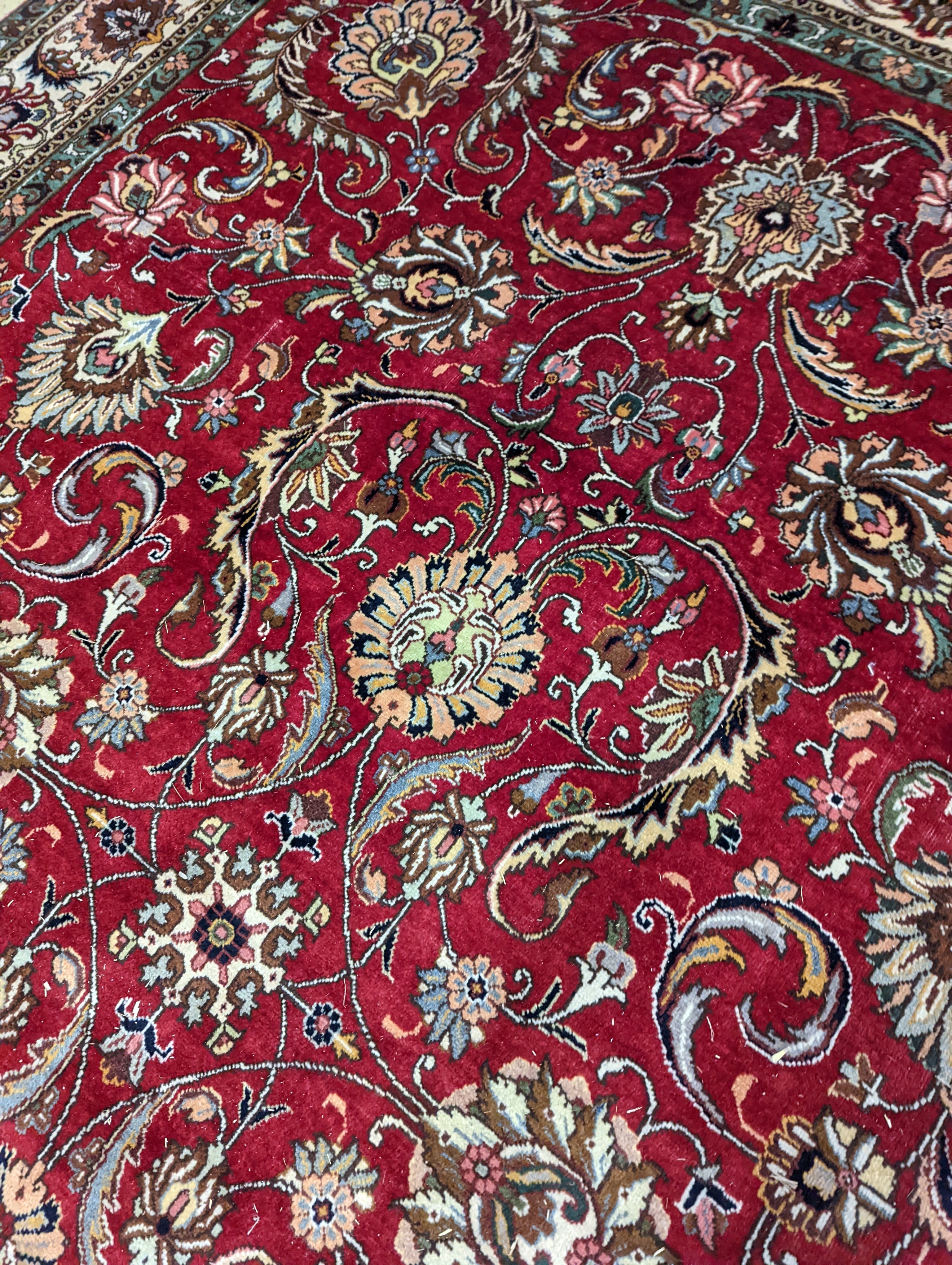 A Tabriz red ground carpet, 400 x 290cm